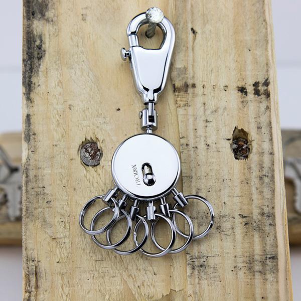 Troika Multi-Ring Patent Keyring in Shiny Chrome Item KYR60/CH Showing On Wood Background Side with Slide button