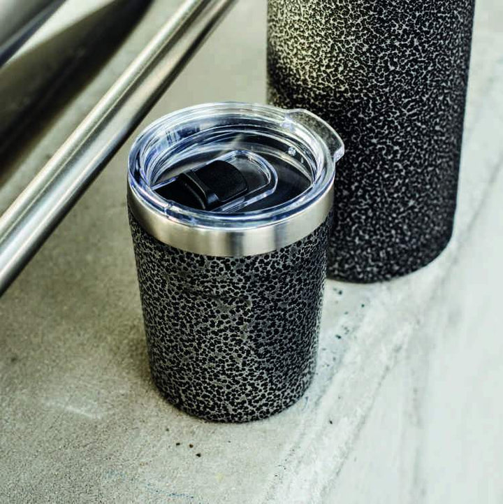 Troika Doppio Espresso Stainless Steel 5.4 OZ Thermos Item CUP65/BL on concrete ledge
